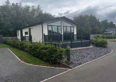 Modern residential park home with a well-maintained garden at Gateforth Park