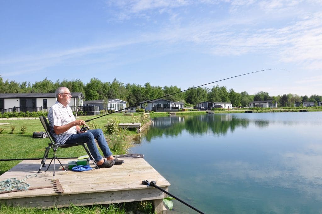 resident of a park home fishing from the private garden