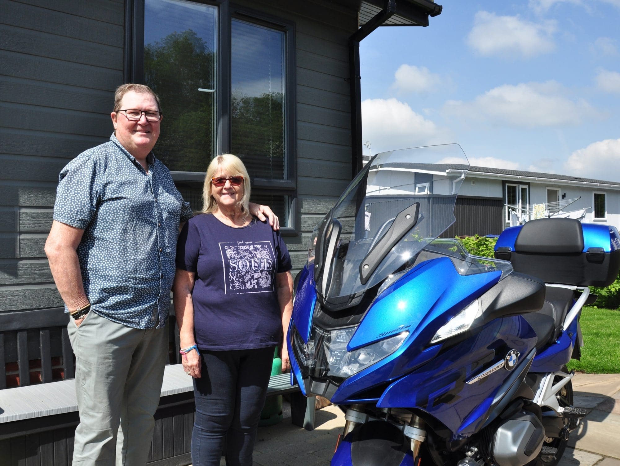 Older couple with motorbike getting the work-life balance right