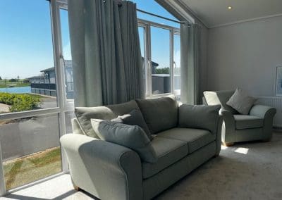 Comfortable living room with large windows and scenic views at Gateforth Park residential park home