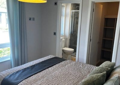 Cozy bedroom with modern decor and en-suite bathroom at Gateforth Park residential park home