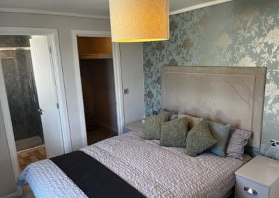 Modern bedroom with a comfortable bed and stylish decor at Gateforth Park residential park home