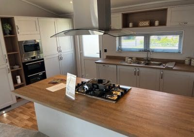 Modern kitchen with a central island and high-quality fittings at Gateforth Park residential park home