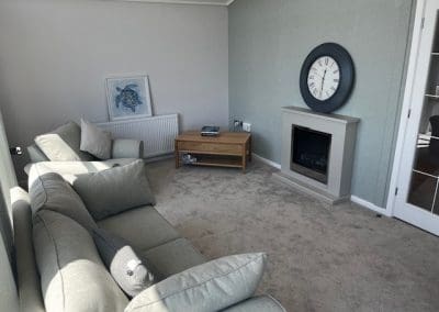 Cozy living room with a fireplace and comfortable seating at Gateforth Park residential park home